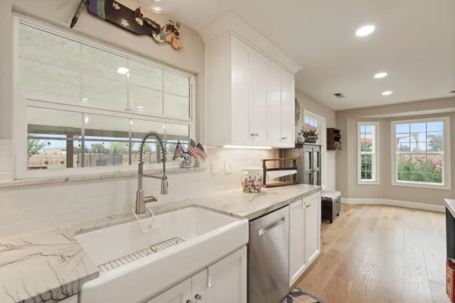 a kitchen with kitchen island appliances a sink and a counter space