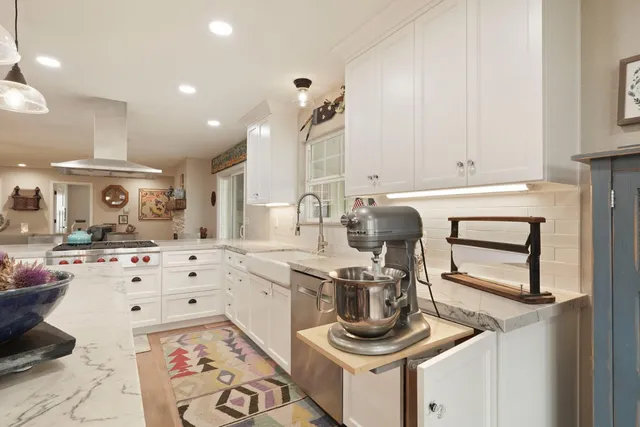 a dining room with furniture a chandelier and wooden floor
