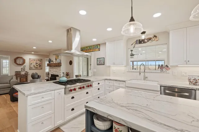 a dining room with furniture a chandelier and wooden floor