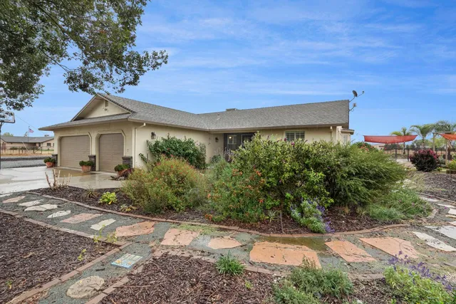 a view of a patio with table and chairs potted plants