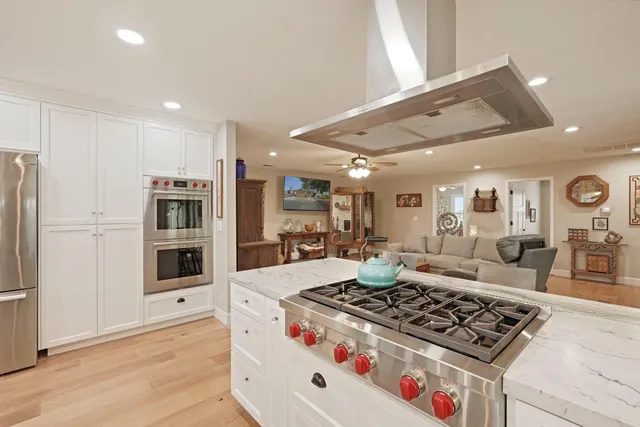a kitchen with stainless steel appliances granite countertop a stove and a refrigerator