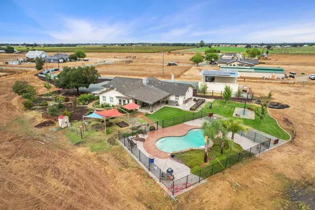 an aerial view of a house with a yard