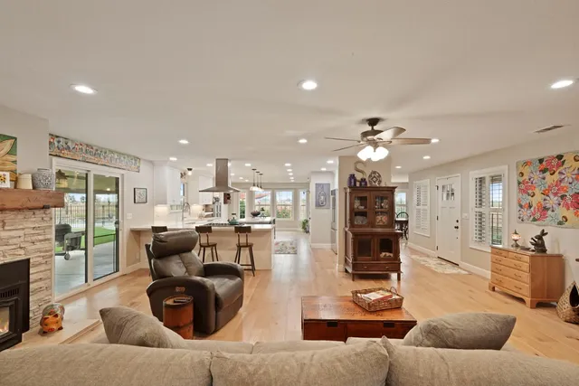 a living room with furniture kitchen view and a fireplace