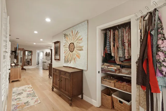 a view of walk in closet with clothes and shoes