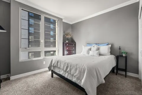 a bedroom with a bed and a window