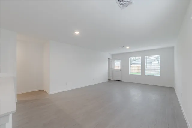 an empty room with windows and entrance