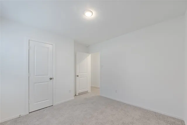 a view of a yard with wooden fence