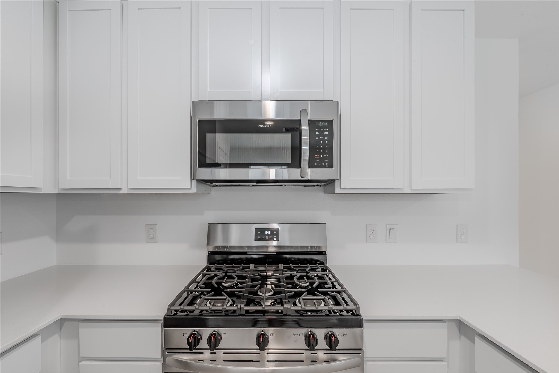 21358 Offida Lane New Caney, TX 77357 - Photo 9 of 26 a kitchen with white cabinets and appliances