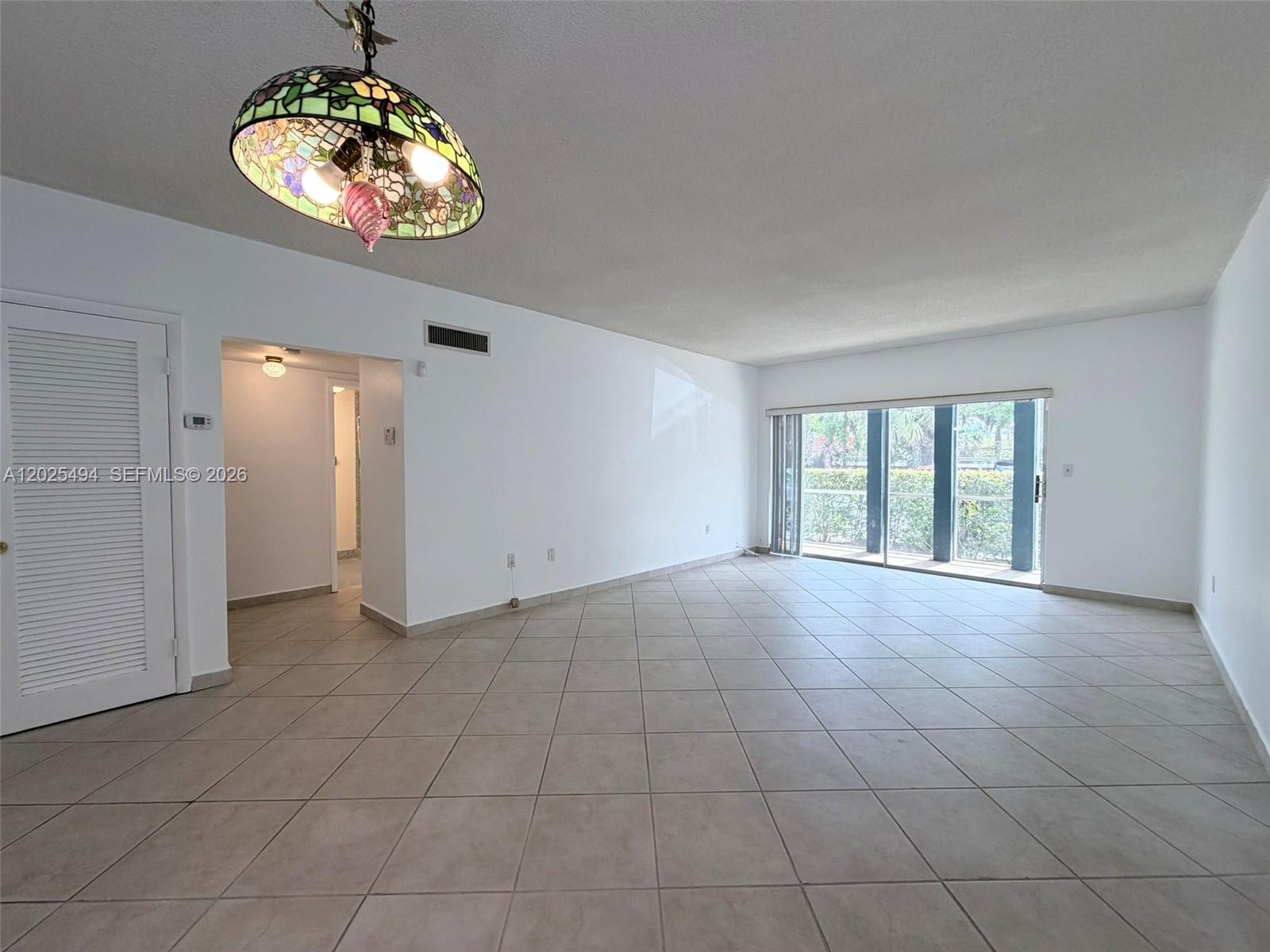 9159 Southwest 77th Avenue, Unit 112 Miami, FL 33156 - Photo 13 of 38 a view of an empty room with a window