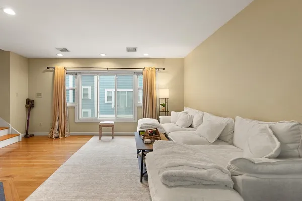a living room with furniture and large windows