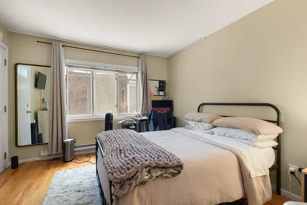 a bedroom with a bed and a window