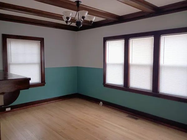 a view of empty room with window and fan