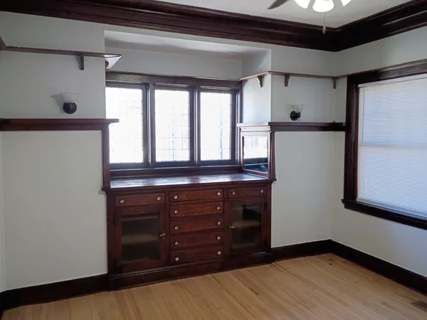 a room with a dresser and a window