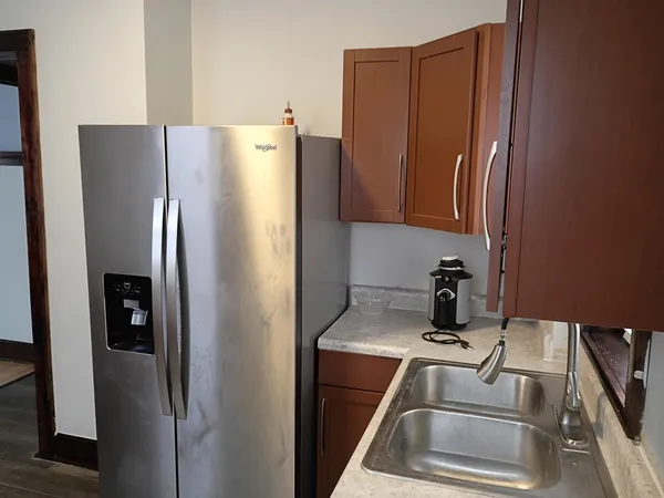 a kitchen with metallic refrigerator freezer and a dishwasher