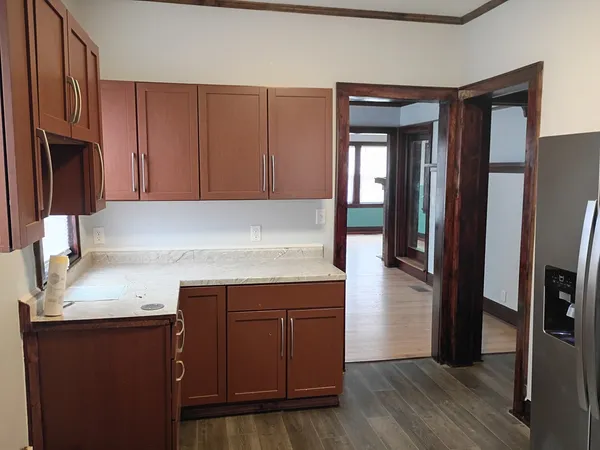 a kitchen with a sink cabinets and wooden floor