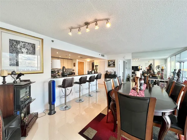 a living room with lots of furniture and floor to ceiling window