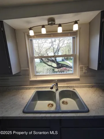 a bathroom with a sink and a window