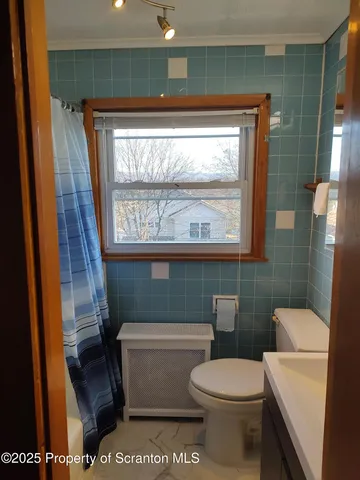 a bathroom with a toilet a sink and a shower