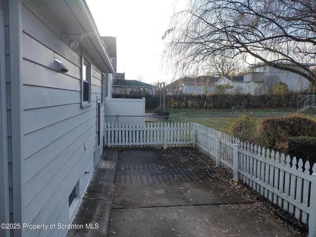 a view of an empty room with wooden walls