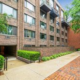 a front view of a building with a garden