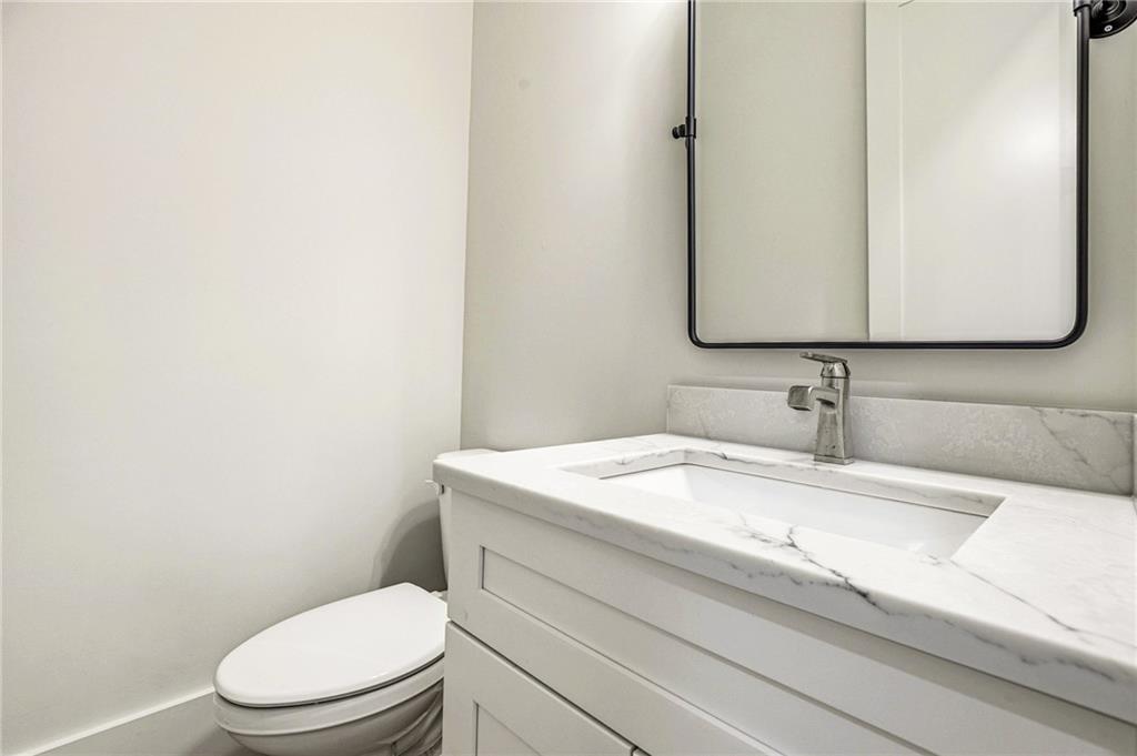 1967 Highgrove Court Decatur, GA 30033 - Photo 47 of 60 a bathroom with a granite countertop toilet sink and mirror