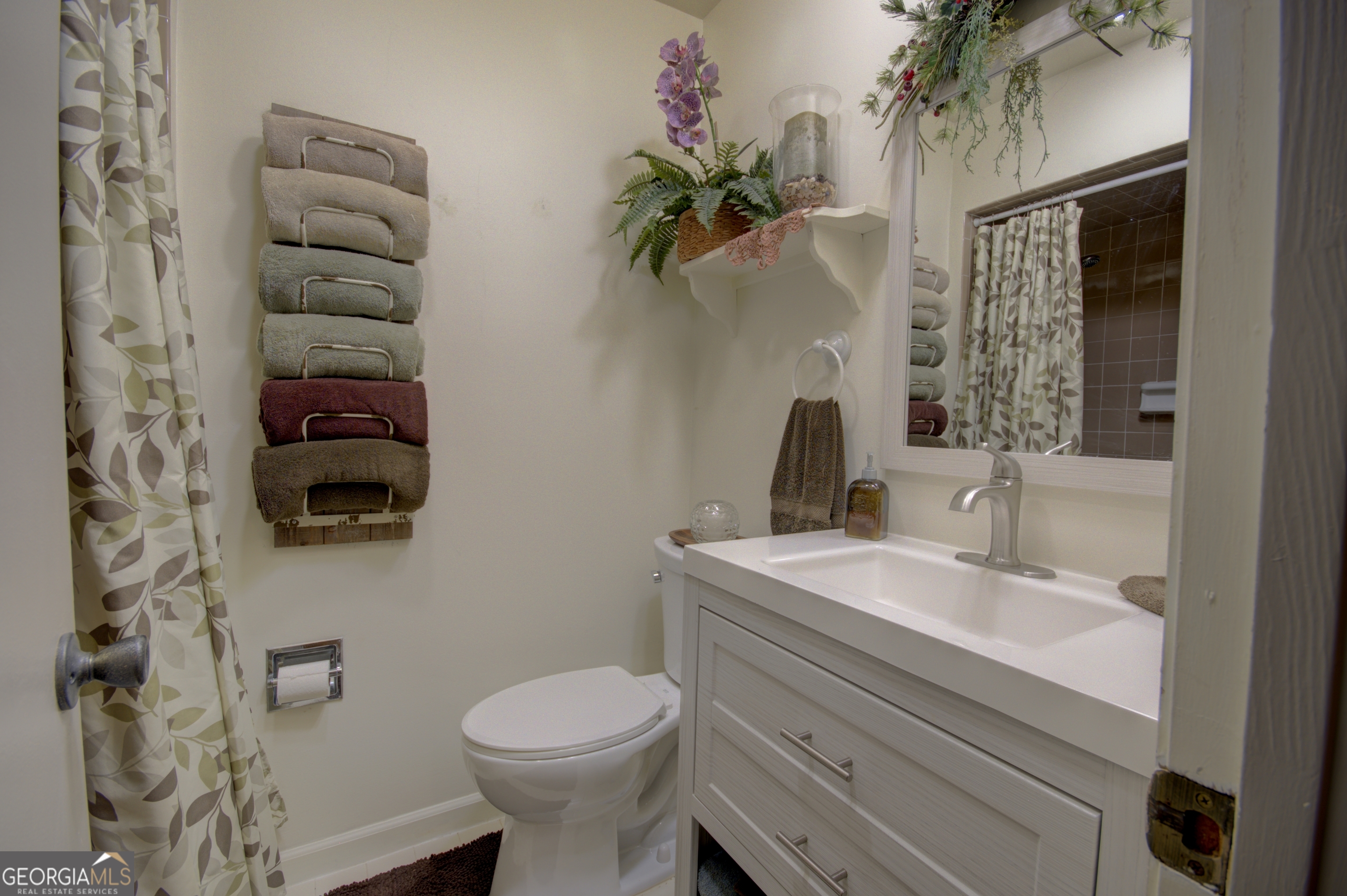 199 Oak Ridge Drive Blairsville, GA 30512 - Photo 107 of 107 a bathroom with a toilet sink and mirror