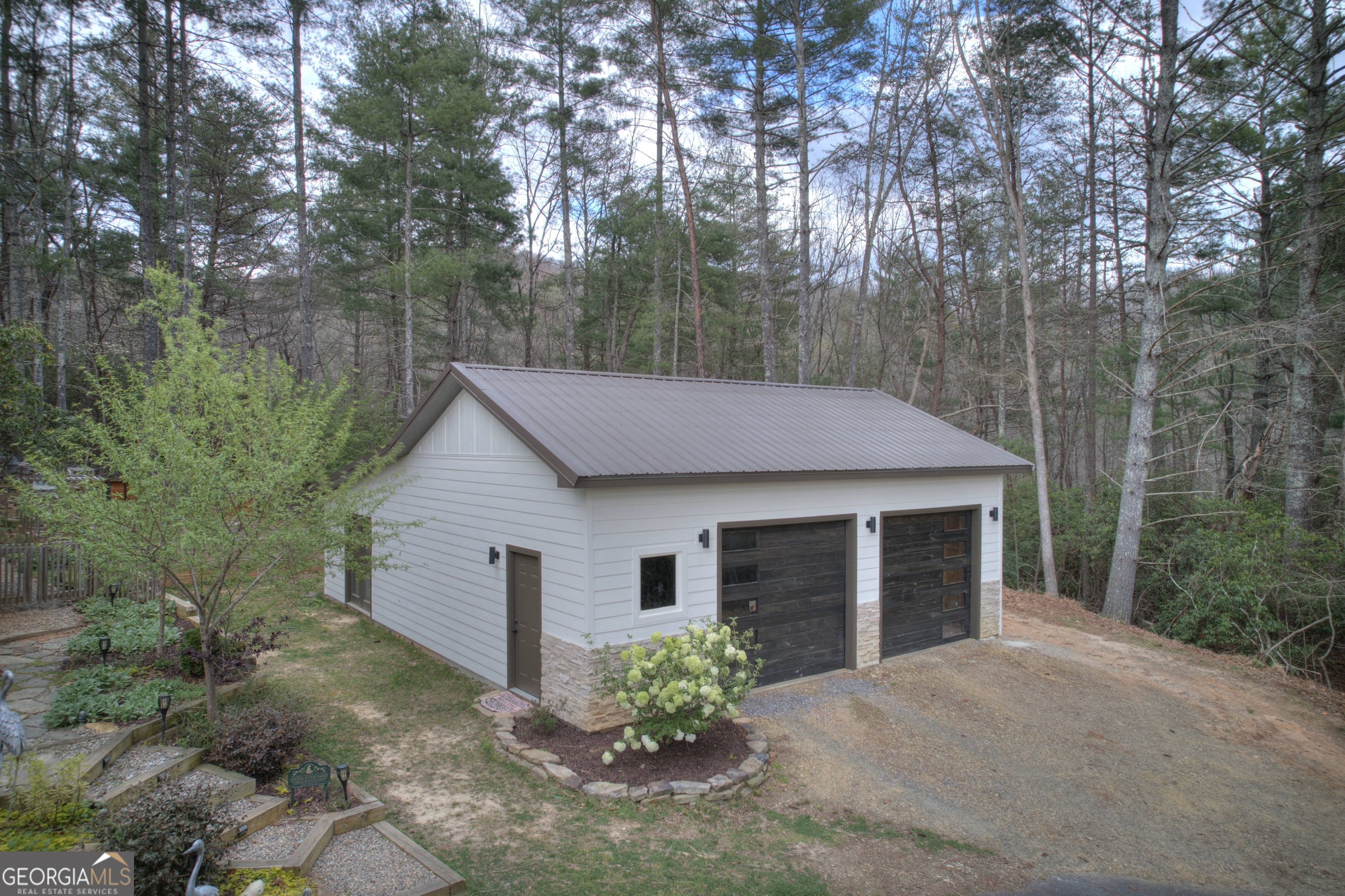 199 Oak Ridge Drive Blairsville, GA 30512 - Photo 20 of 107 a view of a house with a yard and a garden