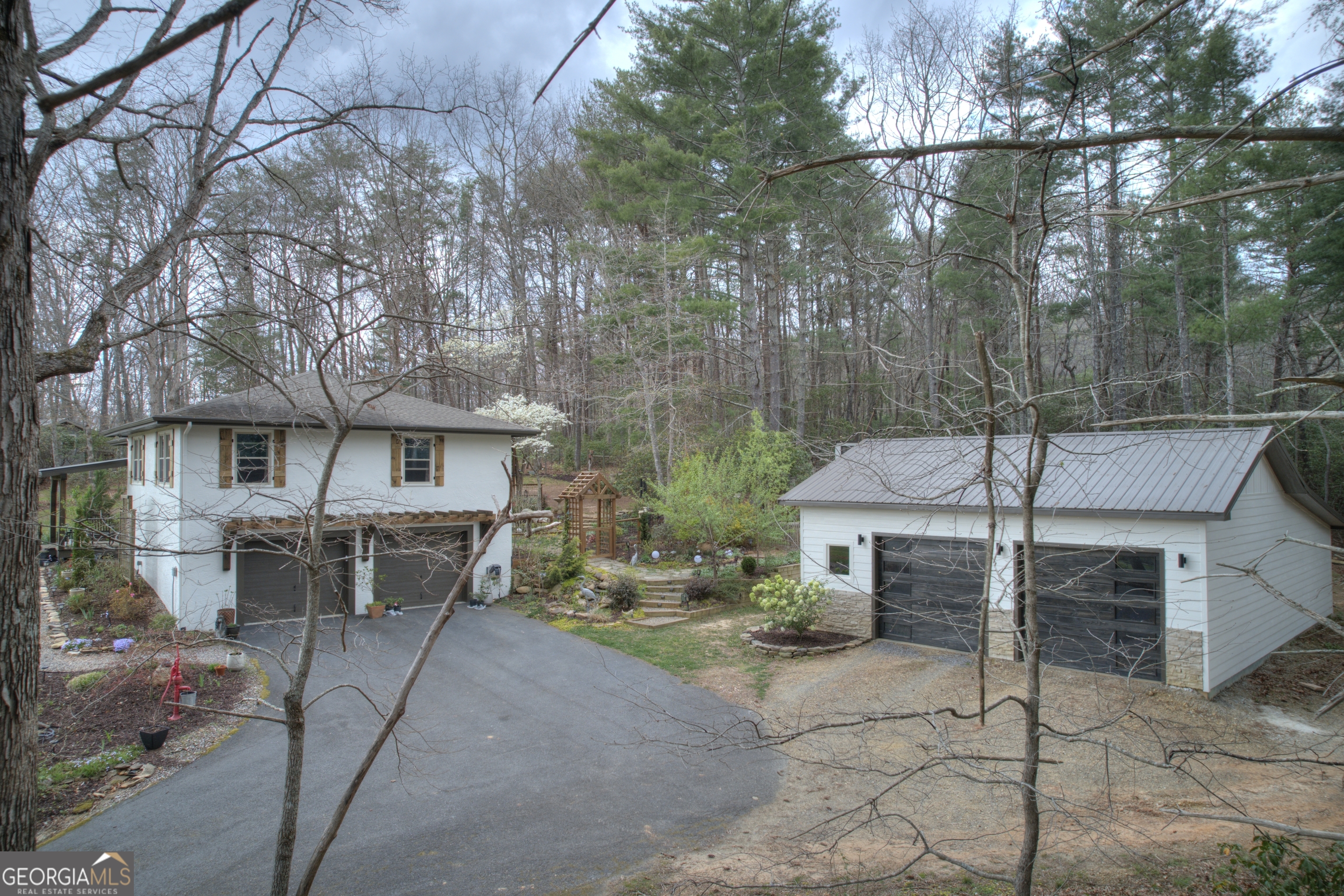 199 Oak Ridge Drive Blairsville, GA 30512 - Photo 22 of 107 a view of a patio with table and chairs and wooden fence
