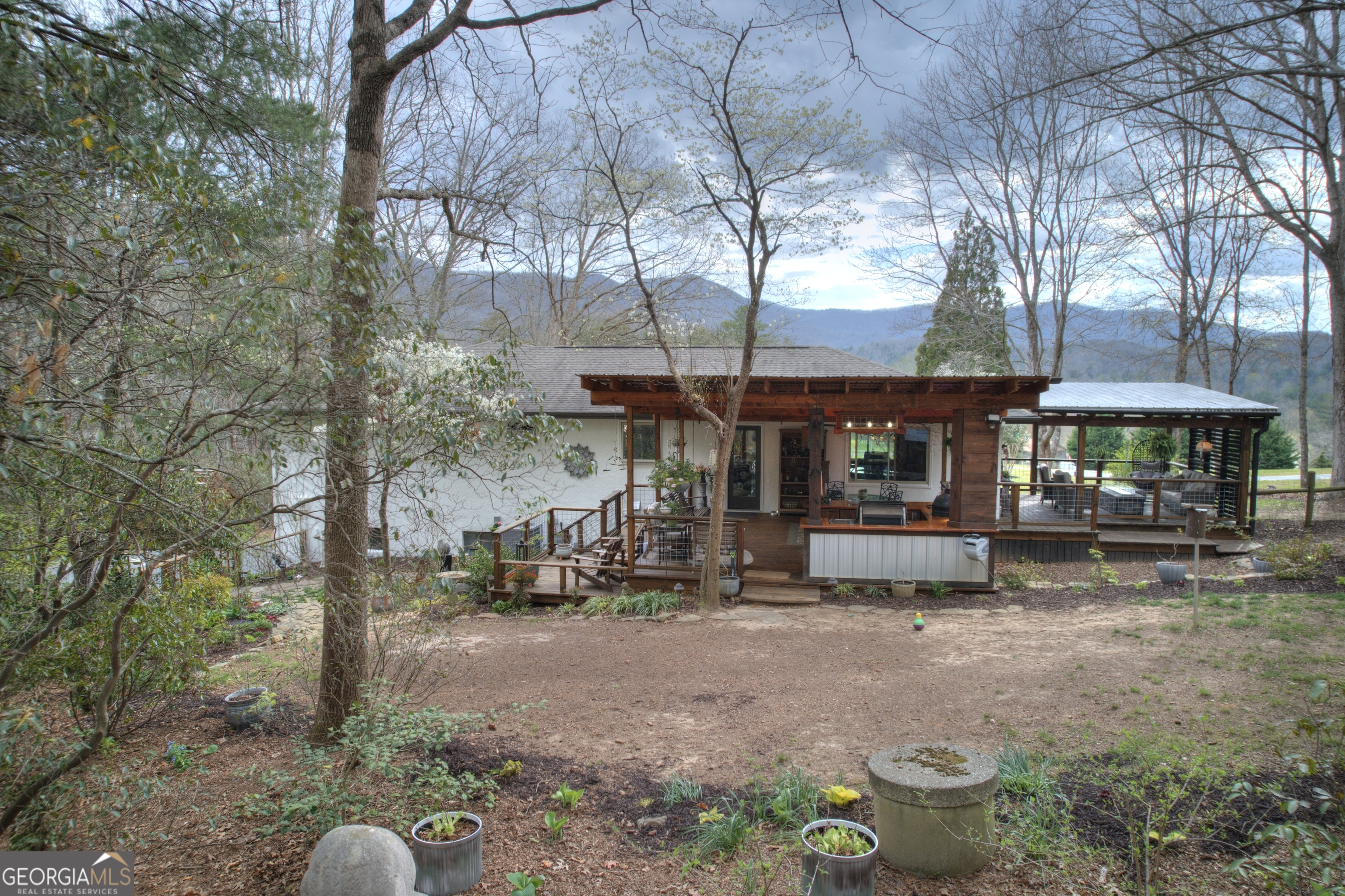 199 Oak Ridge Drive Blairsville, GA 30512 - Photo 28 of 107 a view of a patio with table and chairs under an umbrella