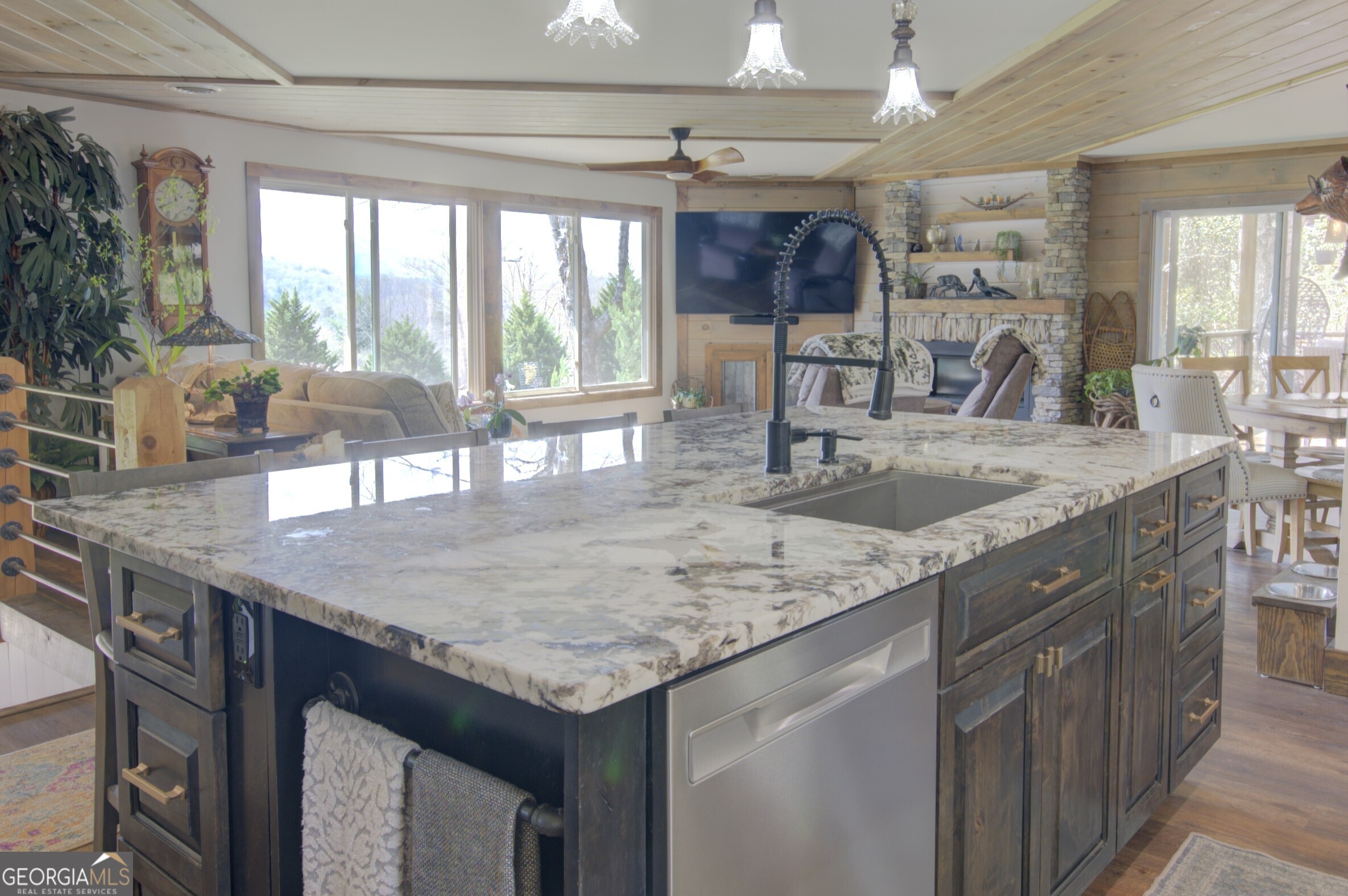 199 Oak Ridge Drive Blairsville, GA 30512 - Photo 60 of 107 a kitchen with granite countertop a sink a counter top space and living room view