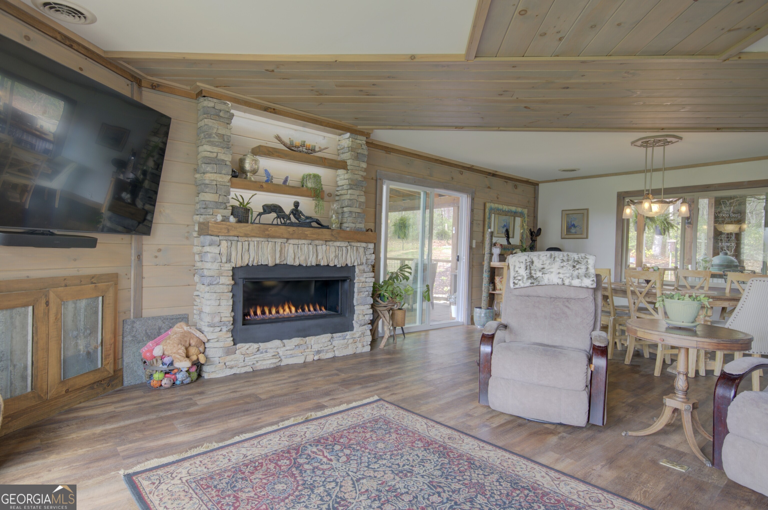 199 Oak Ridge Drive Blairsville, GA 30512 - Photo 68 of 107 a living room with furniture a flat screen tv and a fireplace