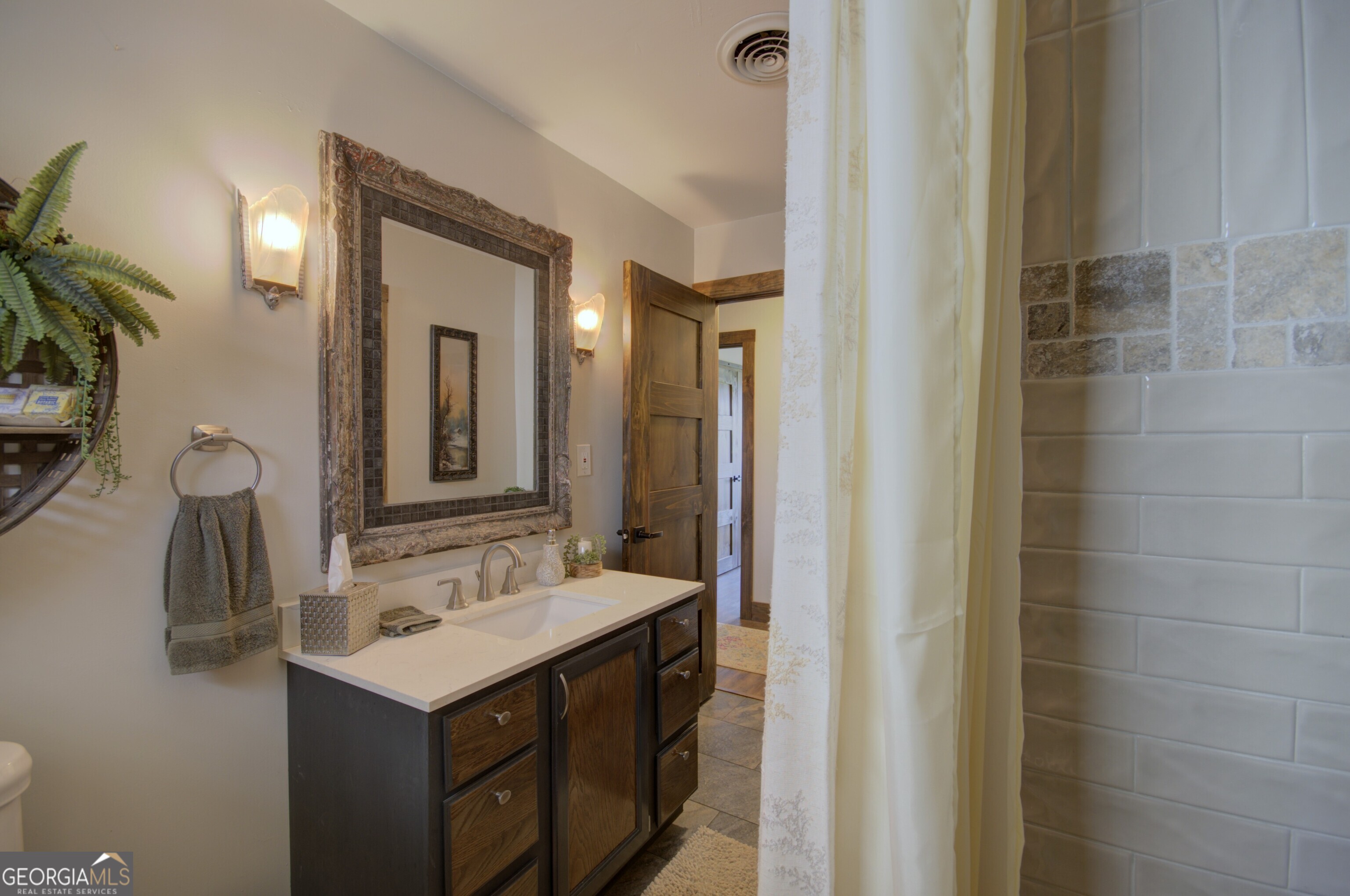 199 Oak Ridge Drive Blairsville, GA 30512 - Photo 96 of 107 a bathroom with a sink and a mirror