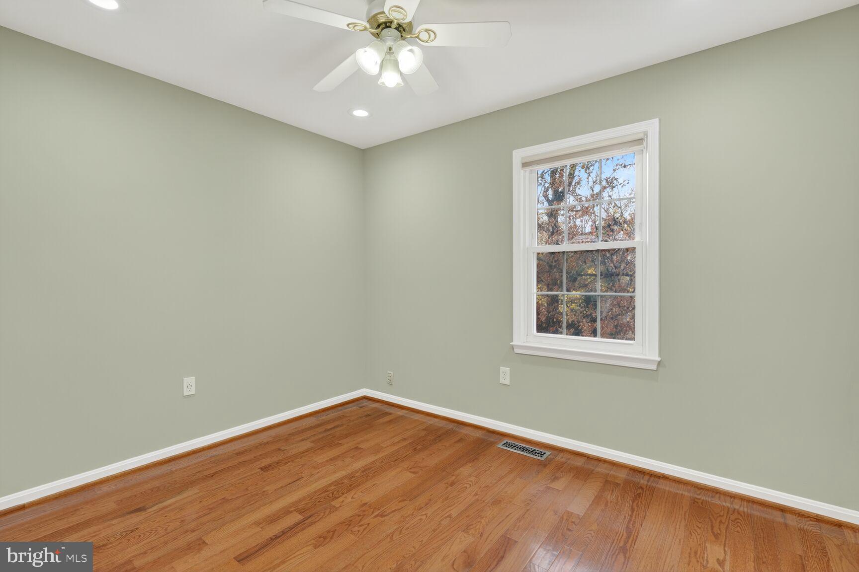 7310 Eggar Woods Lane Springfield, VA 22153 - Photo 15 of 29 an empty room with wooden floor and windows