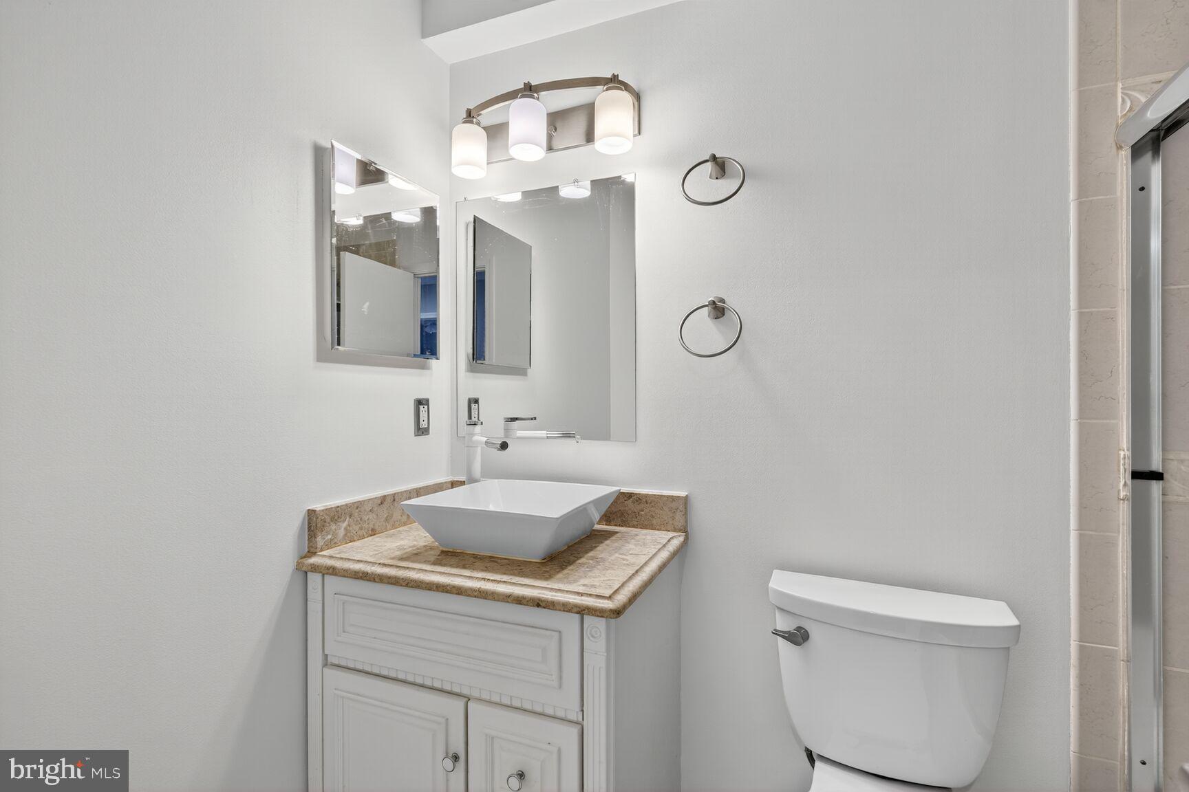 7310 Eggar Woods Lane Springfield, VA 22153 - Photo 17 of 29 a bathroom with a toilet sink and mirror