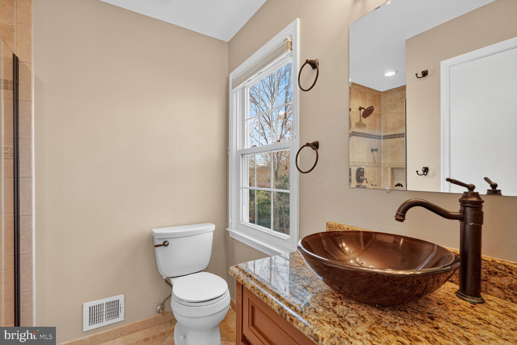7310 Eggar Woods Lane Springfield, VA 22153 - Photo 20 of 29 a bathroom with a toilet and a sink