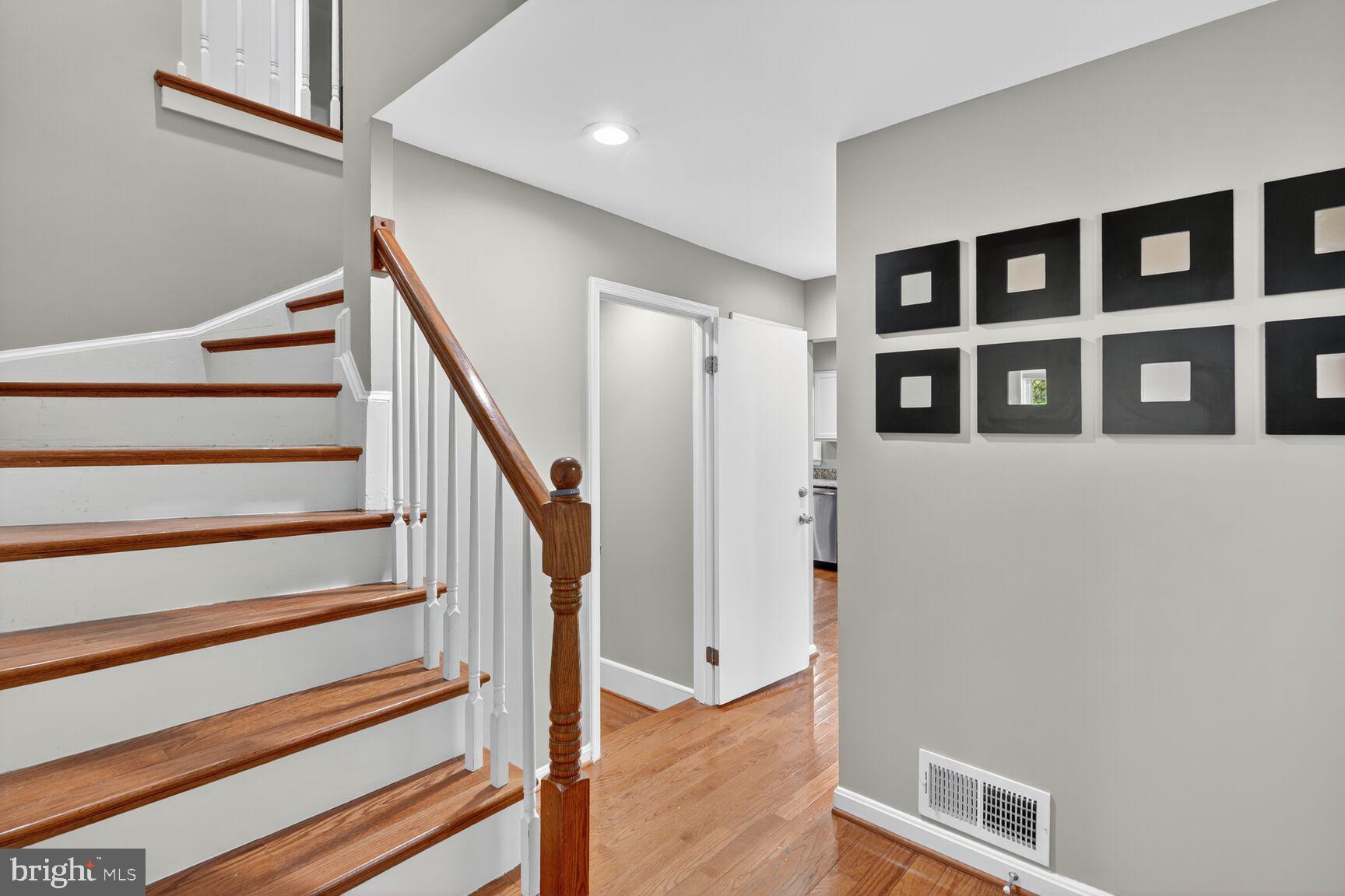 7310 Eggar Woods Lane Springfield, VA 22153 - Photo 2 of 29 a view of entryway with stairs and wooden floor