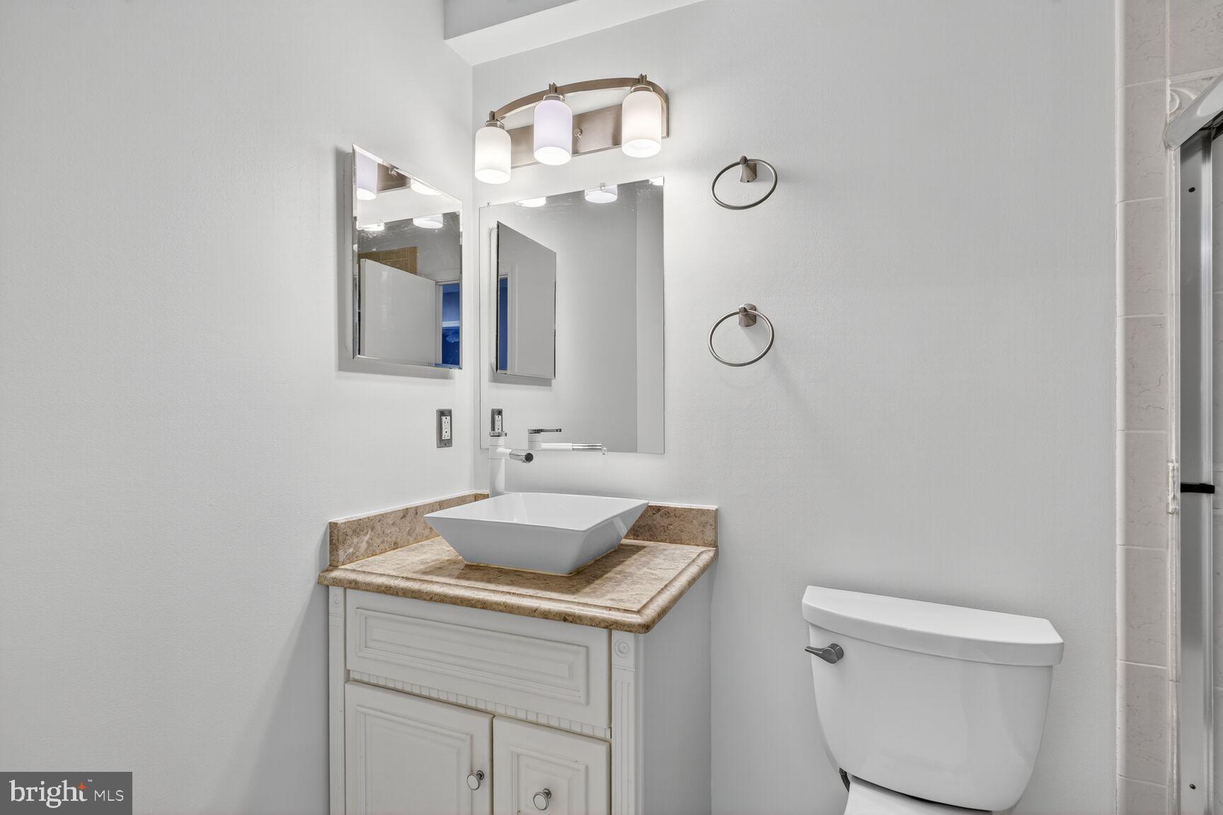 7310 Eggar Woods Lane Springfield, VA 22153 - Photo 21 of 29 a bathroom with a sink toilet and mirror