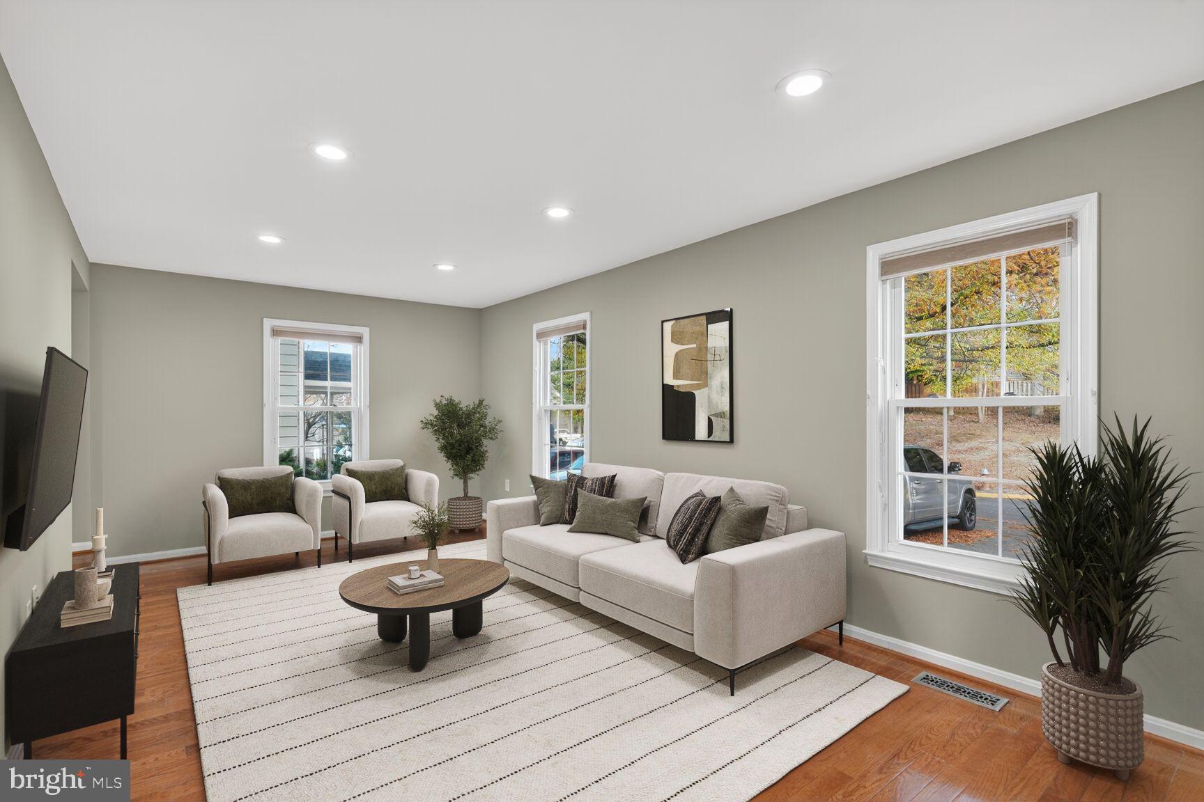 7310 Eggar Woods Lane Springfield, VA 22153 - Photo 4 of 29 a living room with furniture and a flat screen tv