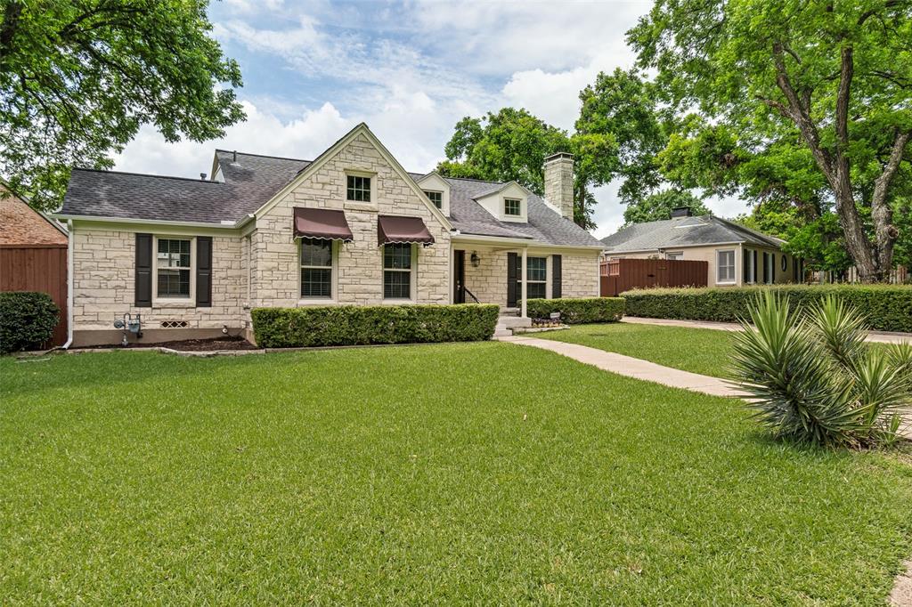 2006 Marydale Road Dallas, TX 75208 - Photo 2 of 40 Stone-clad exterior featuring dark window shutters and awnings