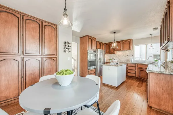 a view of kitchen with furniture and wooden floor