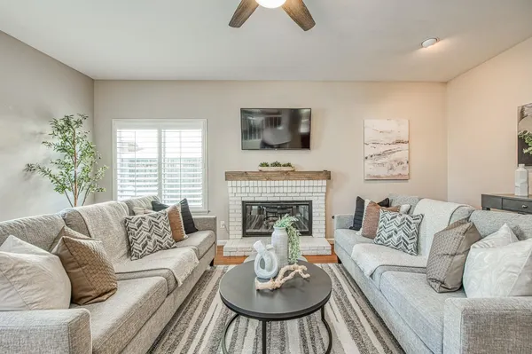 a living room with furniture and a potted plant