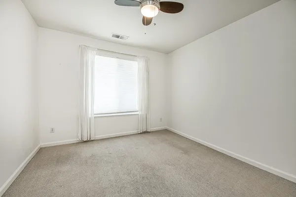 a view of backyard with seating area and wooden fence