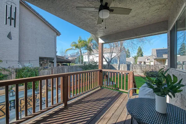 a view of a house with swimming pool lawn chairs and a yard