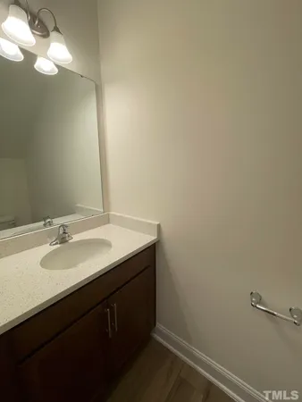 a bathroom with a sink vanity and a mirror