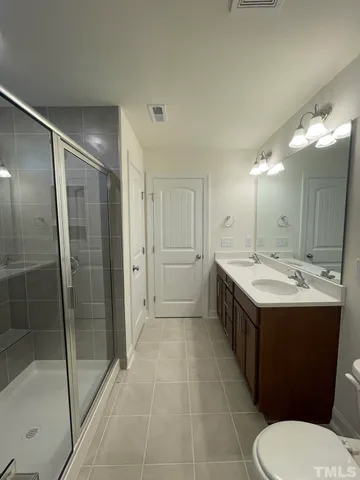 a bathroom with a double vanity sink and mirror