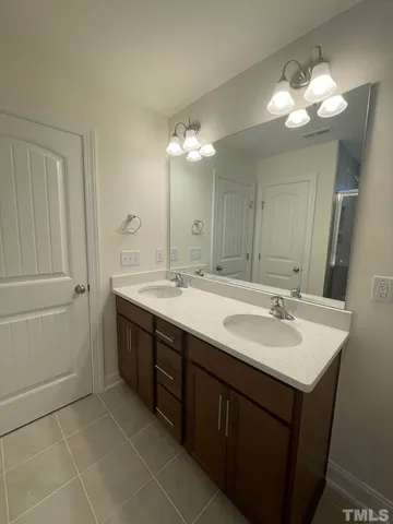 a bathroom with a double vanity sink and a mirror