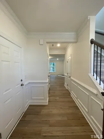 a view of a hallway with wooden floor