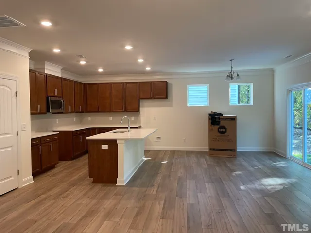 a large kitchen with stainless steel appliances granite countertop a stove a sink and a refrigerator