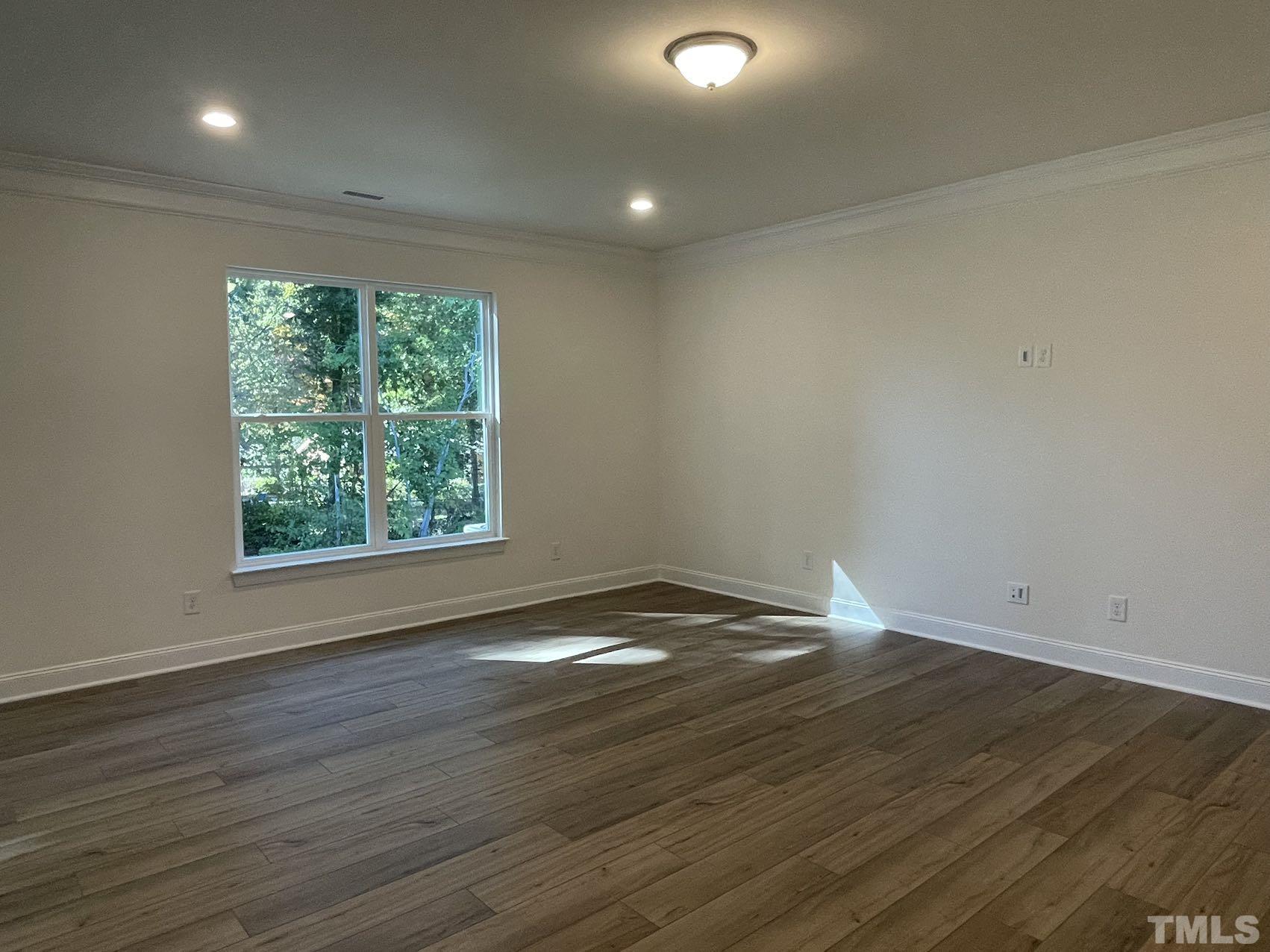 2205 Seneca Road Raleigh, NC 27604 - Photo 10 of 21 an empty room with wooden floor and windows