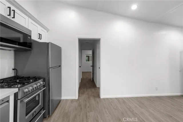 a stove top oven sitting inside of a kitchen